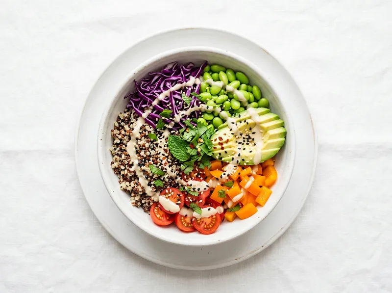 Bunter Regenbogen-Quinoa-Bowl mit Avocado und Tahini-Zitronen-Dressing